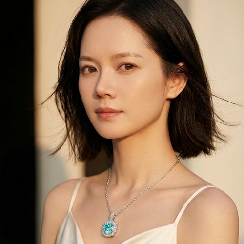 1ct cyan moissanite halo pendant necklace on model — round-cut, ocean blue, 925 silver | TARA AYARH LUNE