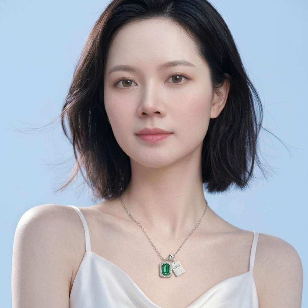 Emerald-cut green moissanite halo pendant with LOVE plaque on model — 5×7mm, 925 silver | TARA AYARH LUNE